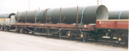 large diameter pipes on flatbed railway wagon