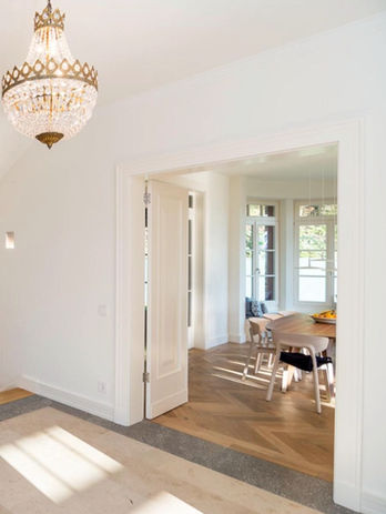 a large living room seen through a double leaf door