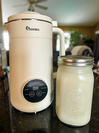 Oat Milk next to milk maker