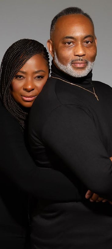 Eric & Tonnie Mills embracing and facing forward, both wearing a black turtleneck