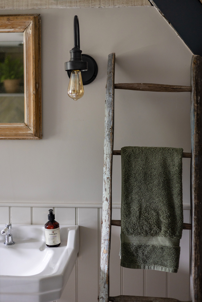"antiques" "Arts & Crafts" "Cotswolds country" "industrial wall light" "limestone floor tiles" "Little Greene Slaked Lime" "modern farmhouse" "natural materials" "rustic" "rustic bathroom" "stone" "texture" "tongue and groove panelling" "vintage ladder towel rail" "vintage mirror" "wall panelling" "natural wood" ""pedestal basin" "classic tap" "neutral bathroom"