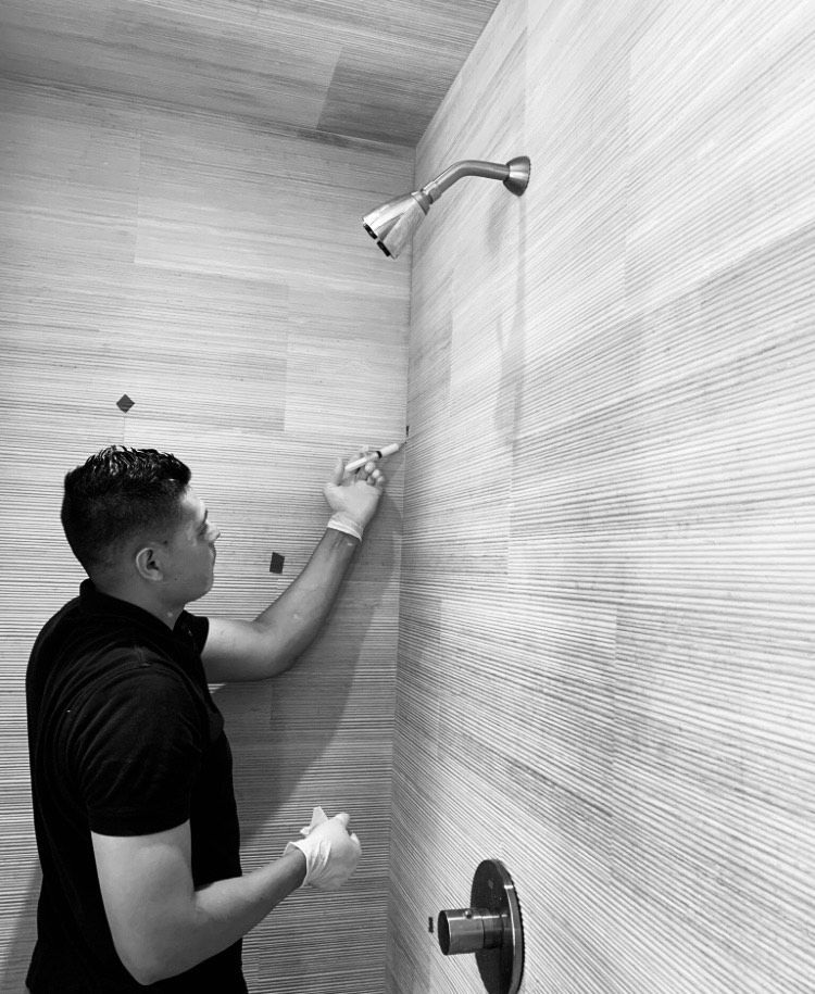 TERSO MR staff member doing maintenance to a stone shower