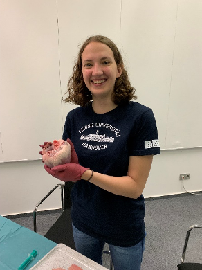 Gallaway holds a heart while assisting at a seminar on valve replacements during the IdeenExpo, a STEM fair for students in Hannover.