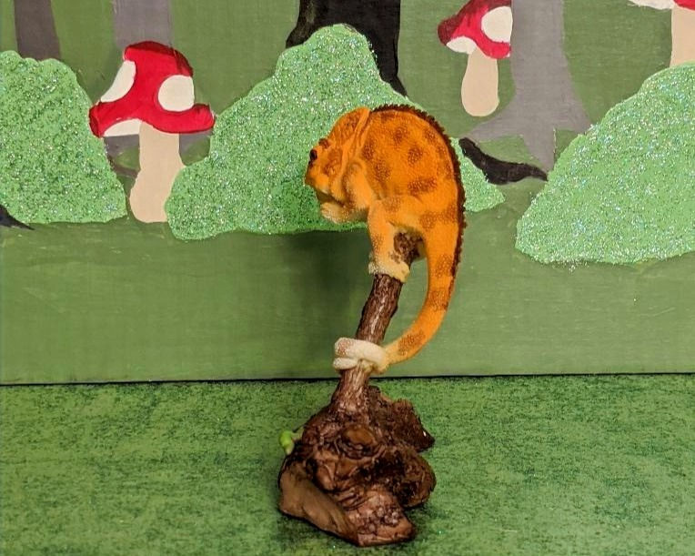 Thumbnail: Miniature Chameleon on Branch with Caterpillar