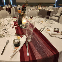 Wedding reception table with red runner, candle