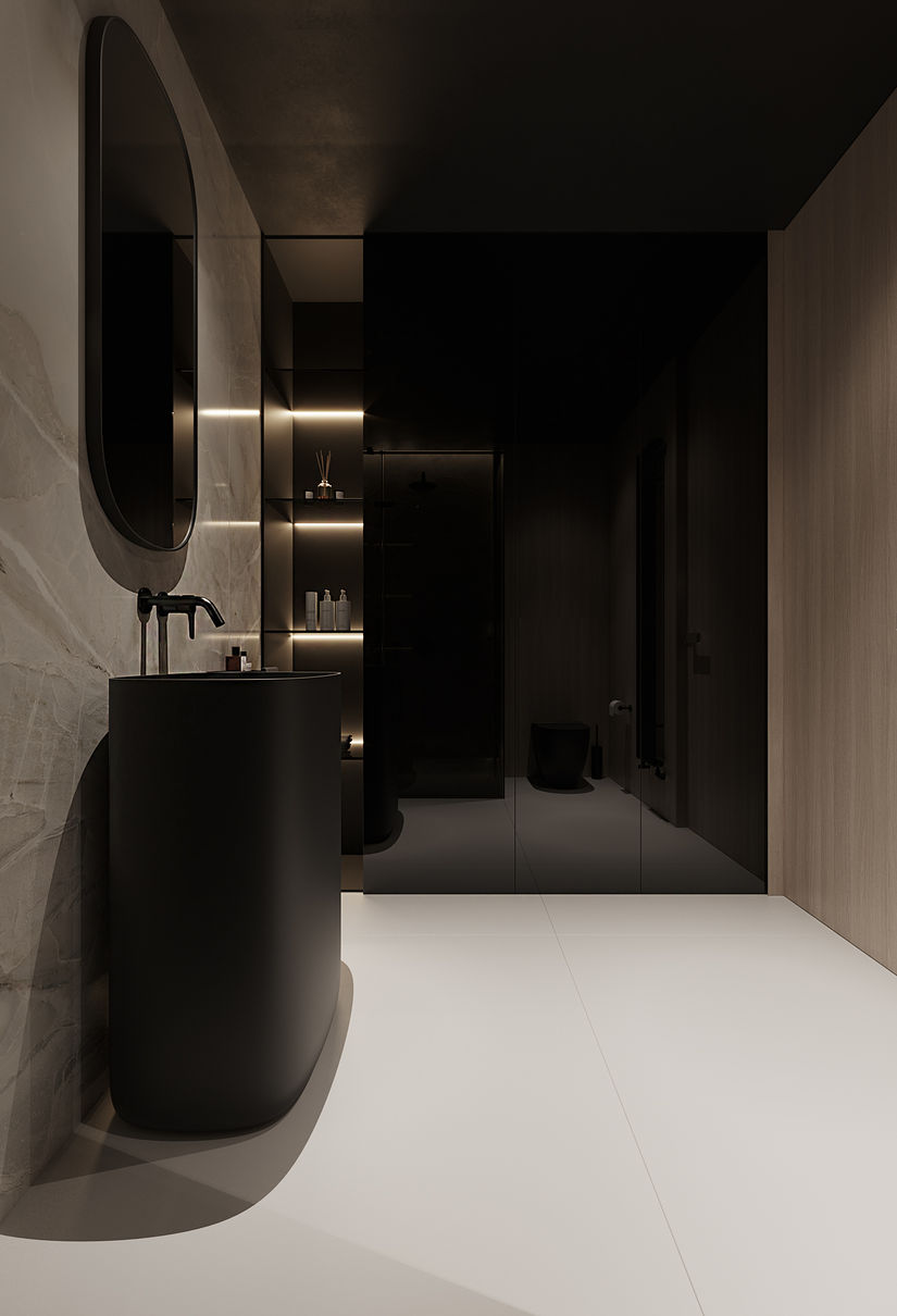 W eleganckiej łazience apartamentu nad polskim morzem minimalistyczny design spotyka się z wyrafinowaną estetyką. Dominuje w niej kontrast między matową czernią a jasnym wykończeniem, które nadaje przestrzeni nowoczesny i luksusowy charakter. Ściany wykończone zostały eleganckimi płytami o subtelnym wzorze marmuru, a czarne, matowe akcenty w postaci armatury oraz oryginalnej umywalki wprowadzają nutę dramatyzmu i wyrafinowania.

Przestronna kabina prysznicowa z ciemnym, transparentnym szkłem idealnie wpisuje się w minimalistyczną estetykę wnętrza, a subtelne oświetlenie LED nad prysznicem oraz przy półkach dodaje delikatnego blasku. Czarne, zintegrowane z systemem grzewczym grzejniki oraz owalne lustro bezramkowe uzupełniają całość, tworząc harmonijną kompozycję. Łazienka ta to synonim współczesnej elegancji, która łączy funkcjonalność z estetycznym wyrafinowaniem.