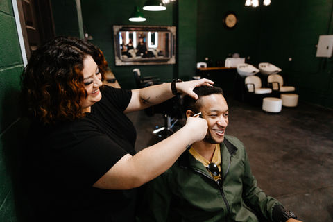 woman cutting mans hair
