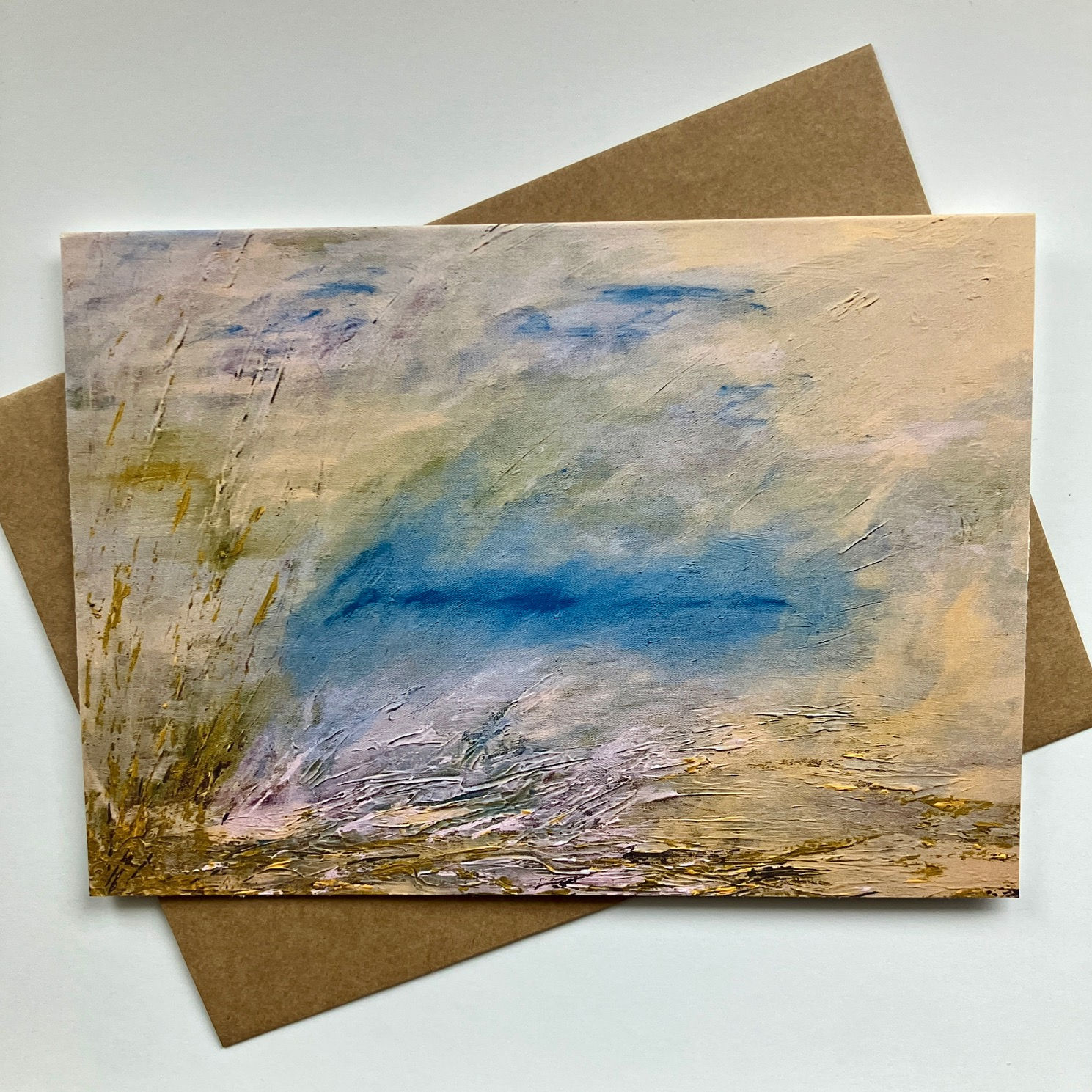 Original handmade blank art card featuring and abstract landscape of yellows, blues, green, and gold.