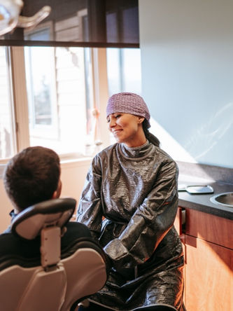 Michelle Strange, The Roaming Dental Hygienist, talking to a patient in her clinic.