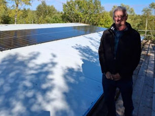 man in front of a solar panel