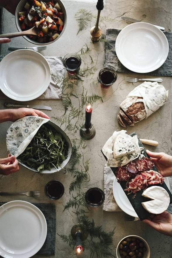 A table with various dishes and food wrapped in beeswax wrap