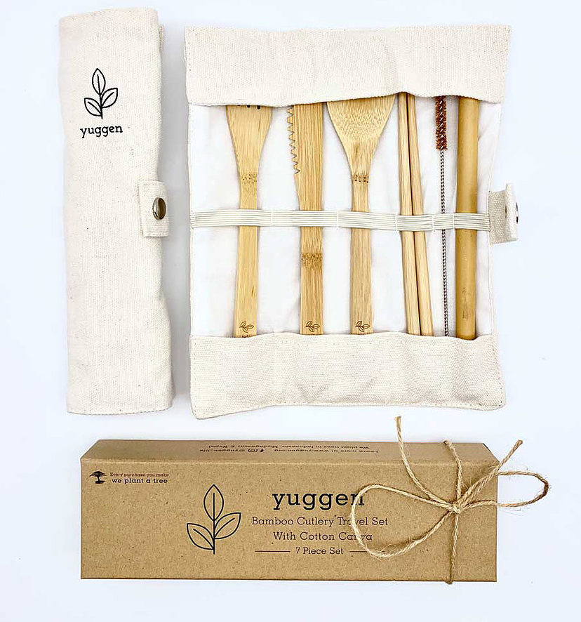A box, a pouch and a cutlery set displayed flat. The pouch is displayed closed and open with a fork, knife, spoon, chopstick, brush and a straw