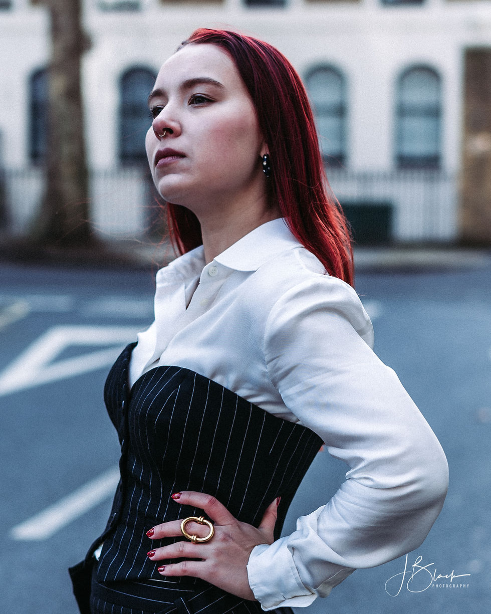 Tatiana dressed in a hite satin shirt and a pinstripe corset by Moschino.