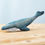 Thumbnail: Bumbu Toys Wooden Blue Whale. A handcrafted wooden sea creature with soft blue tones and painted details, shown on a wooden