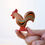 Thumbnail: Bumbu Toys Wooden Rooster in hand. Handcrafted Waldorf inspired small world toys. Imaginative play and storytelling.