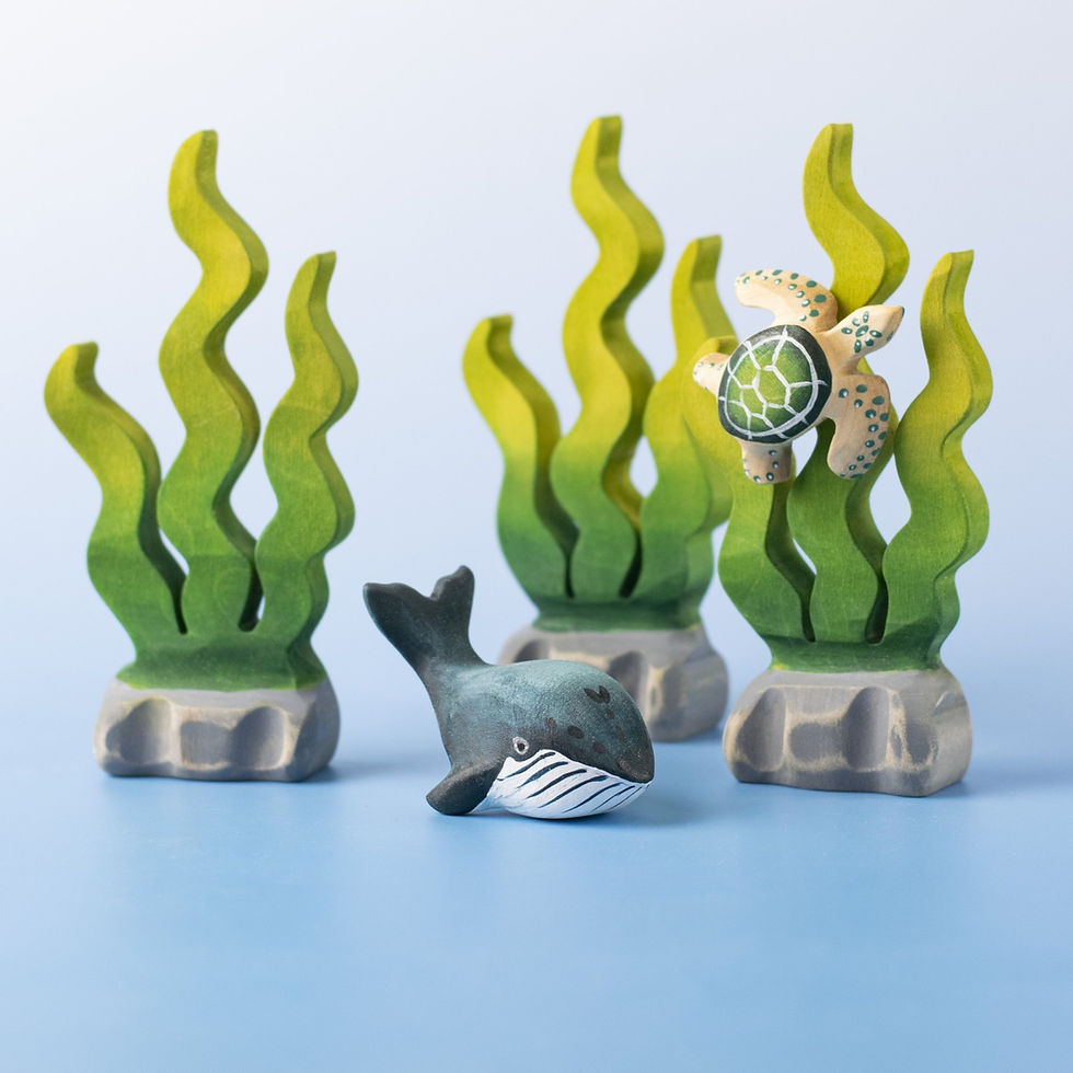 Thumbnail: Bumbu Toys Wooden Baby Blue Whale in a small world scene with green seaweed and a sea turtle.