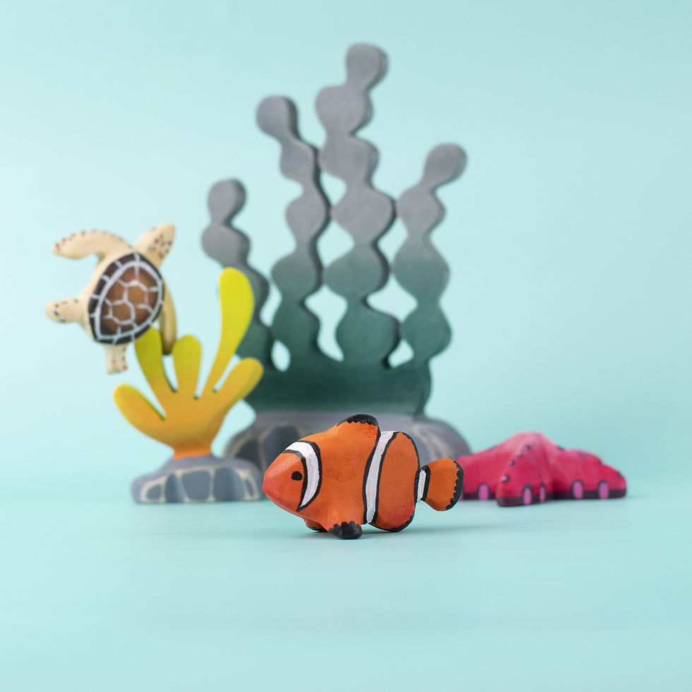 Bumbu Toys Wooden Clownfish surrounded by sea creatures and coral reef pieces in a colourful underwater play setup