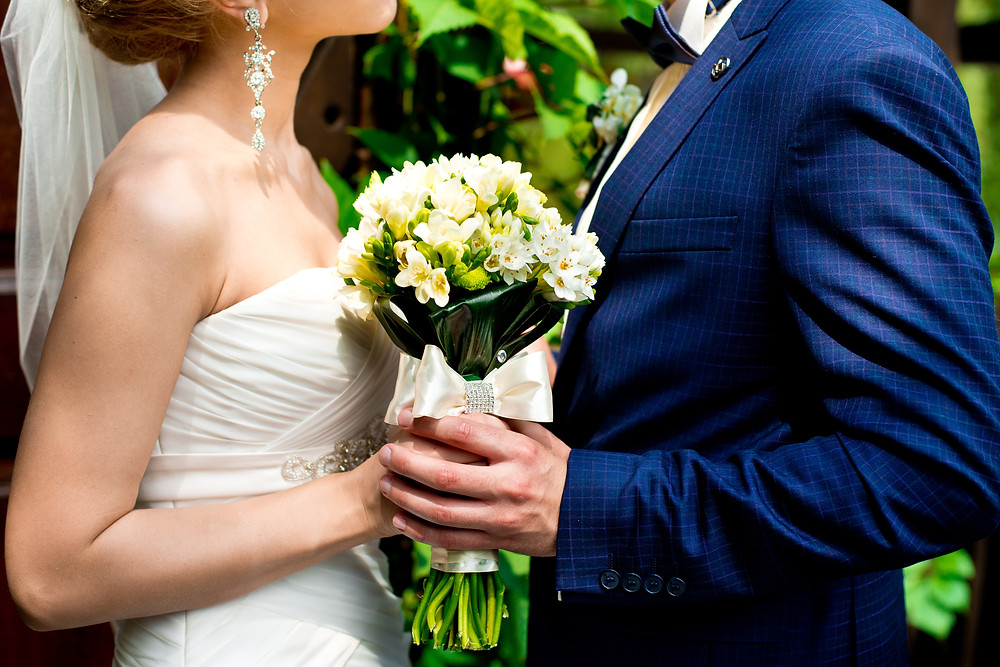 Married couple holding bouquet
