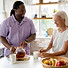 african-social-worker-helping-senior-woman.jpg