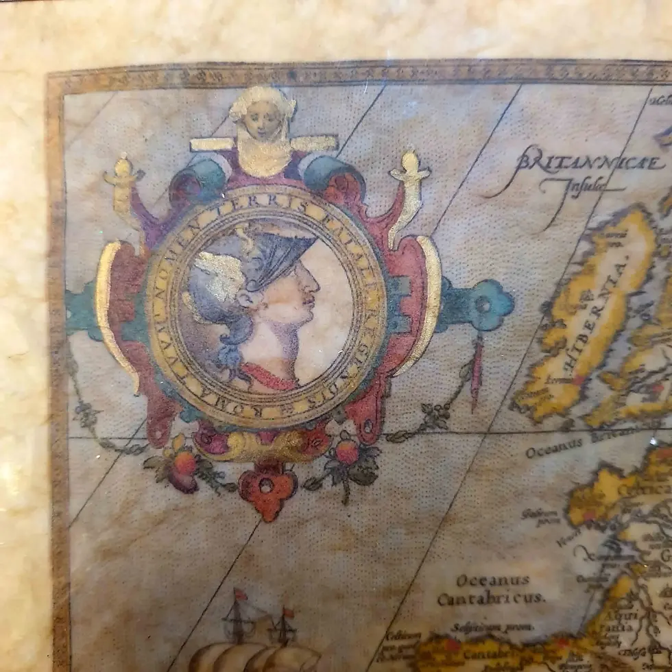 A close-up detail of the Roman Empire map showing the medallion of Romulus and Remus being raised by a she-wolf. The medallion is surrounded by ornate decoration with gold highlights.