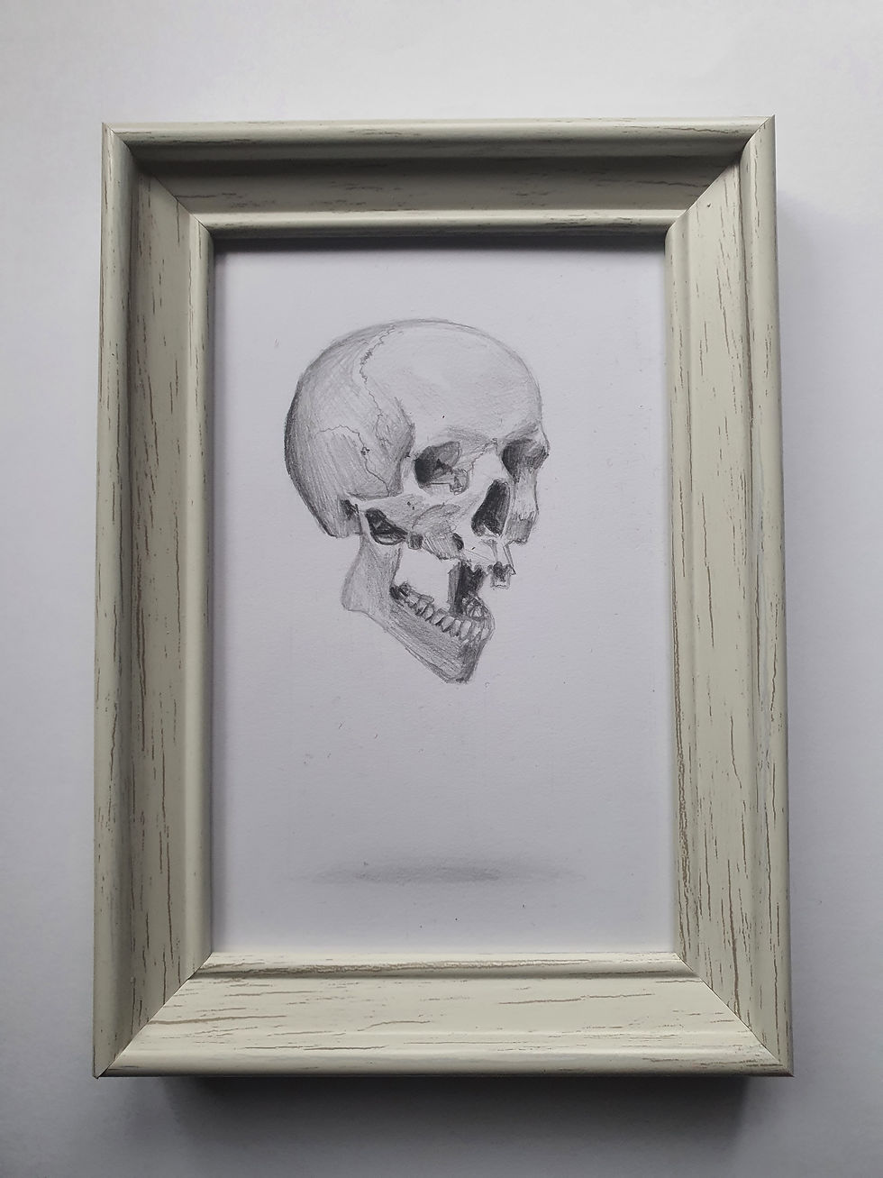 Framed picture of a hand drawn floating skull in pencil