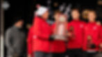 Mick Byrne holding the 4th place team trophy on the podium at the 2024 NCAA XC Championships // Photo via Andrew LeMay