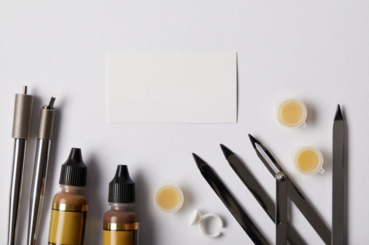 stock-photo-top-view-tools-permanent-makeup-white-paper-isolated-white.jpeg