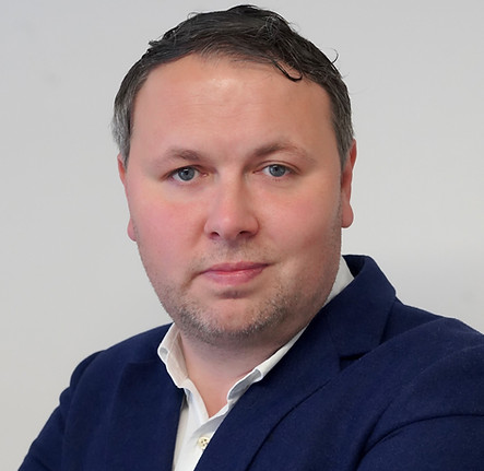 Man in blue suit with arms crossed