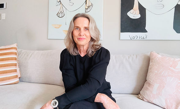 Lisa Moore, a warm and professional integrative therapist, seated on a neutral-toned couch, offering compassionate support at Headstrong Counselling