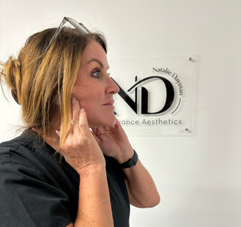 Older Woman pulling excess skin back of saggy jowls