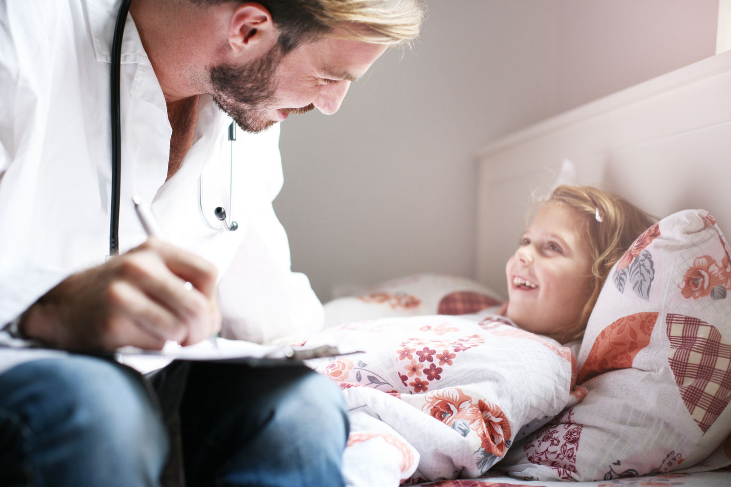 Young male doctor visiting his little patient in hospital..jpg