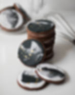 Professional food photography styled and captured. Stack of cookies with black and white icing on a white table.