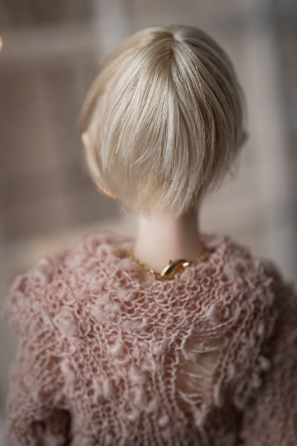 Handmade angora goat hair wig with a short pixie cut and side-swept bangs.