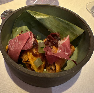 Raw meat served in elegant bowl with leaves and sauce and garnish. Salad style from Michelin-star Topolobampo in Mexico City