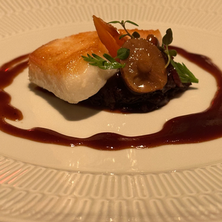 Chilean Sea Bass served on beautiful plate with garnish and set up.  Photograohed by Jabri Fine Dining