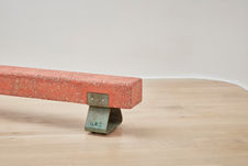 Composite concrete stone and mineral beach with textured finish on patinated steel legs suitable indoor and outdoor use