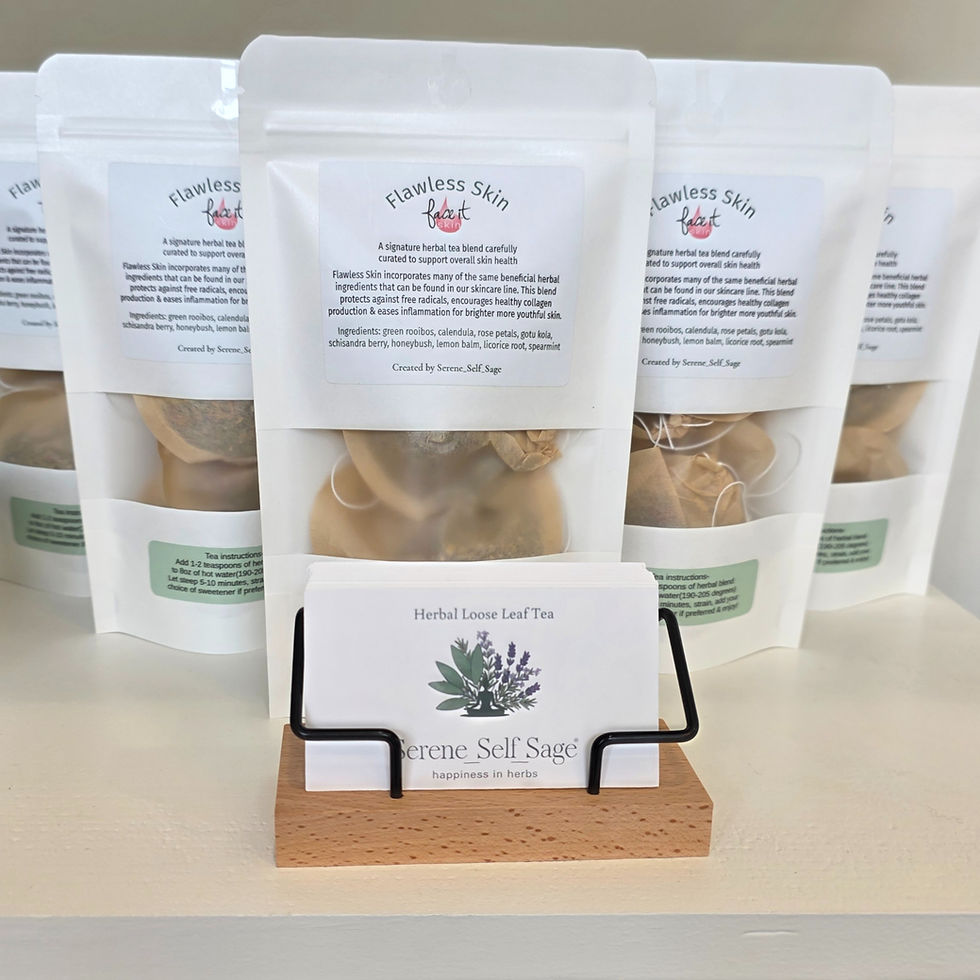 Herbal tea packs labeled "Flawless Skin" displayed on a shelf with business cards in a wooden holder. White and neutral tones dominate.