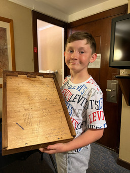Noah holding a bedside draw to show guest comments