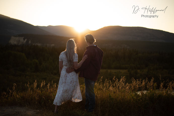 An intimate moment between a young couple enjoying a beautiful mountain sunset in Fairmont Hot Springs, BC