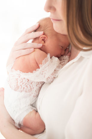 Mother lovingly holding her newborn baby