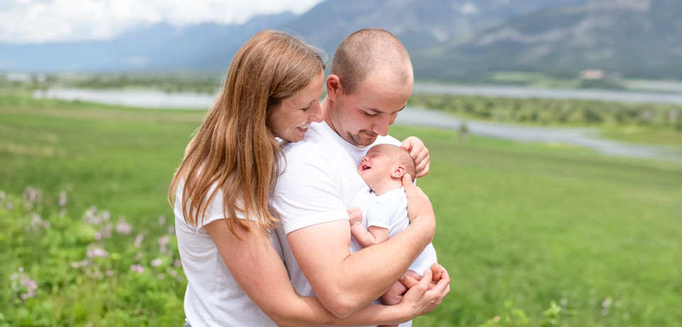 new parents admiring their little newborn baby boy