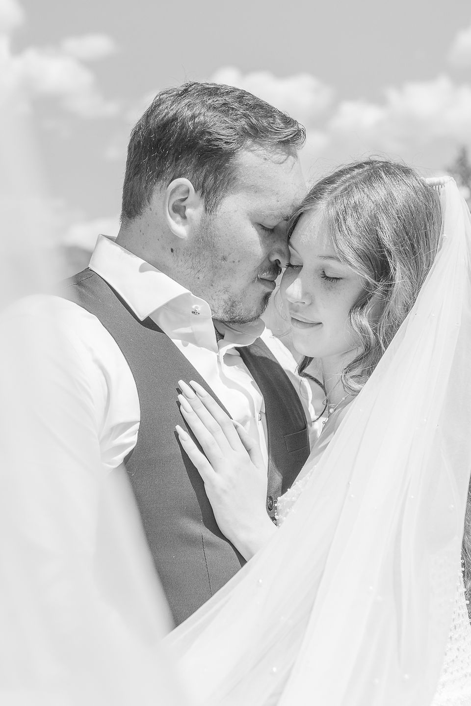 Couple embracing an intimate moment during their wedding. The image is black and white. Captured by Invermere Wedding Photographer