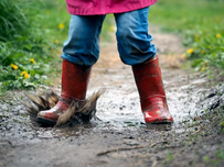 A kid stomping in mud.
