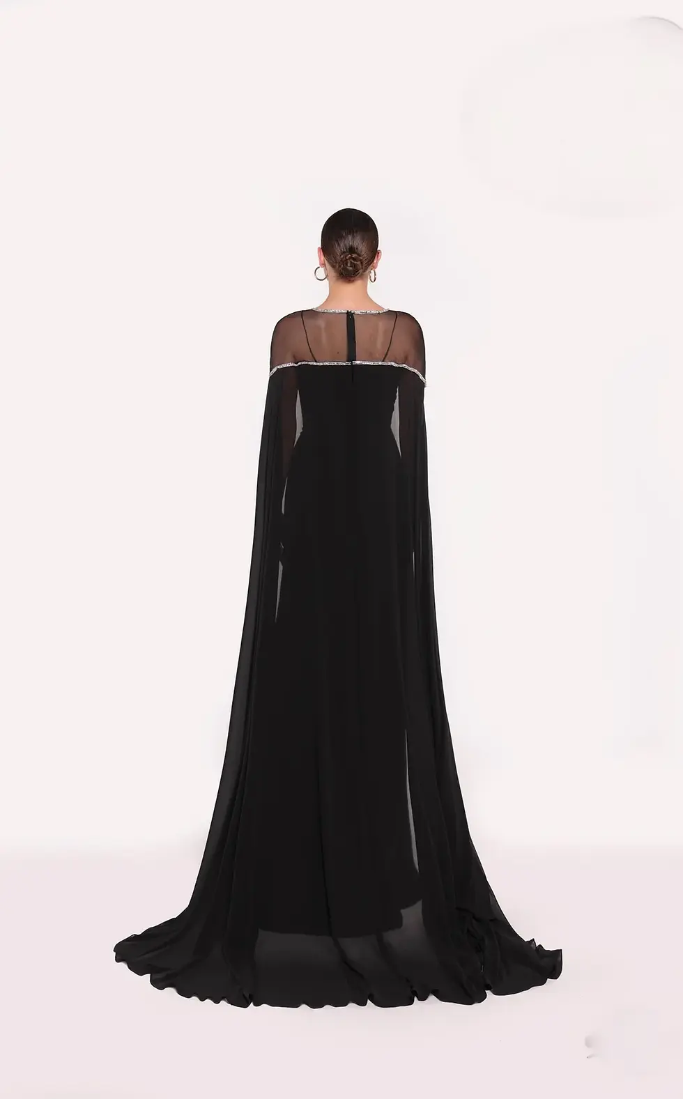 Royal blue cape gown with sheer illusion neckline and silver embellishment.