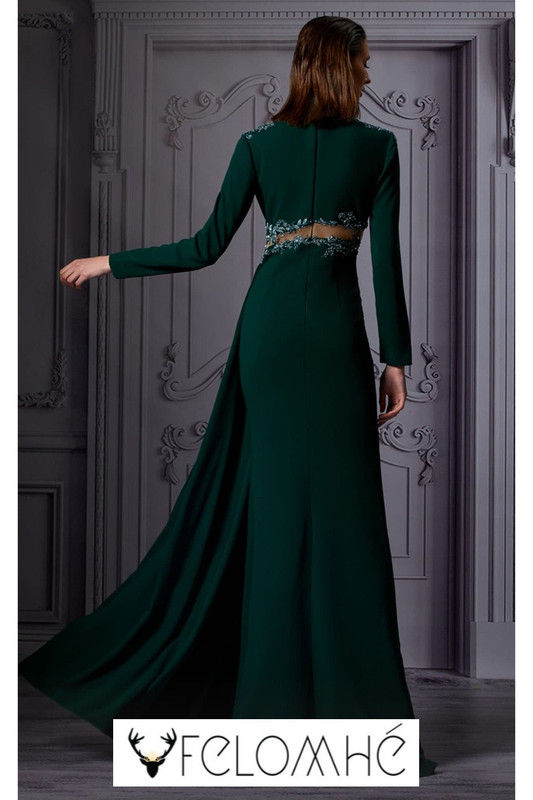 Emerald green high-neck gown with silver embellishments, bold cutouts, and a flowing silhouette, designed for red carpets