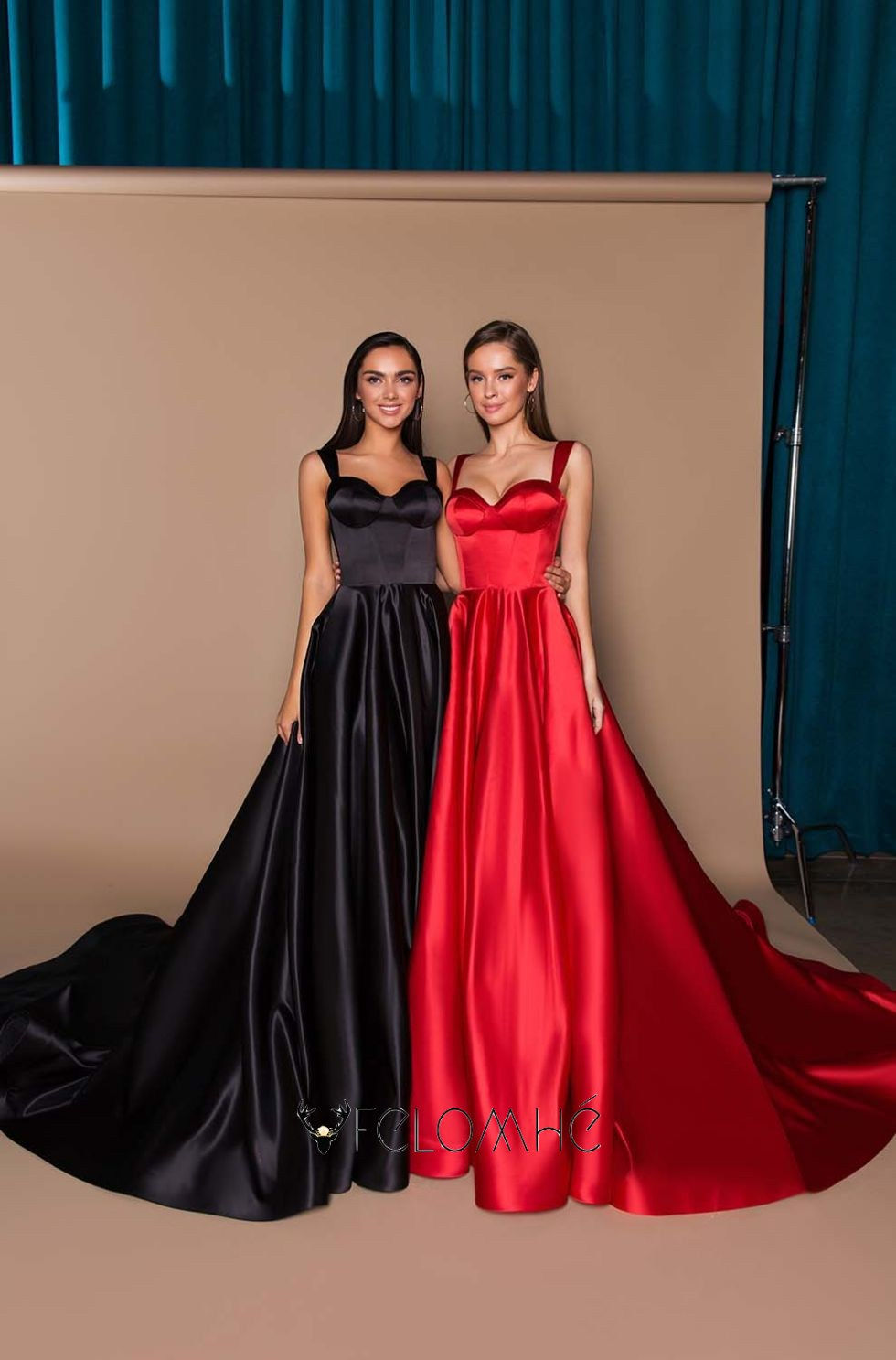 Black and red satin corset gowns with a fitted silhouette and flowing train, ideal for glamorous evening occasions.