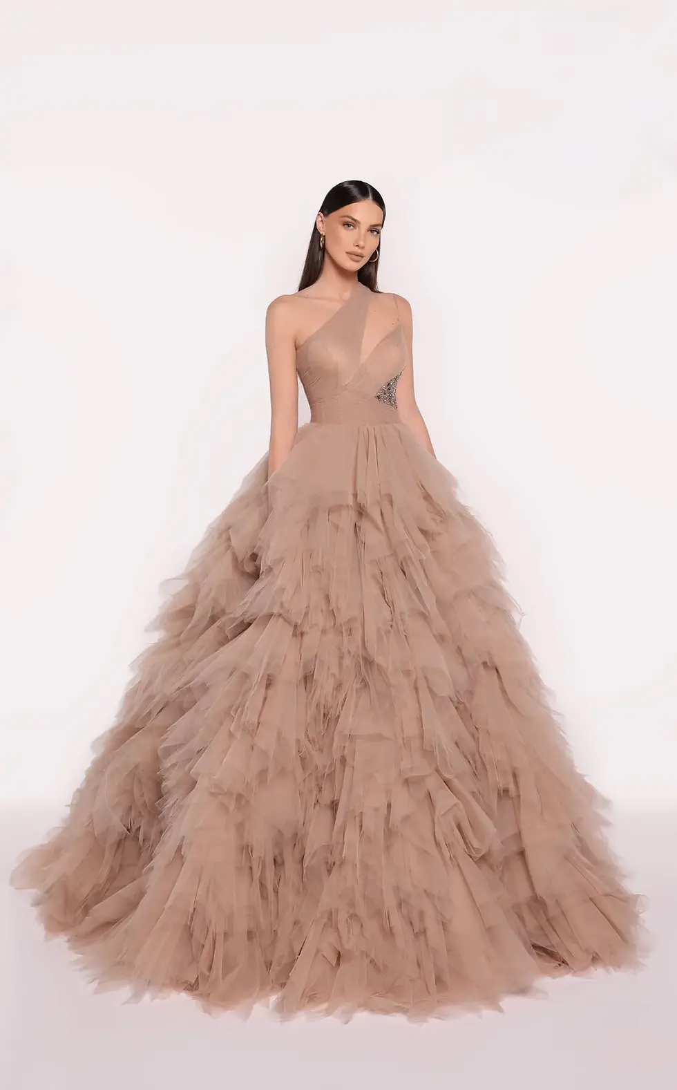 Nude one-shoulder tulle ball gown with a ruched bodice and voluminous skirt.