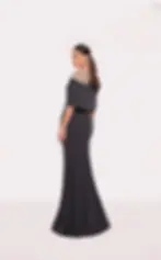 Navy blue evening gown with a silver beaded illusion neckline and cape sleeves.