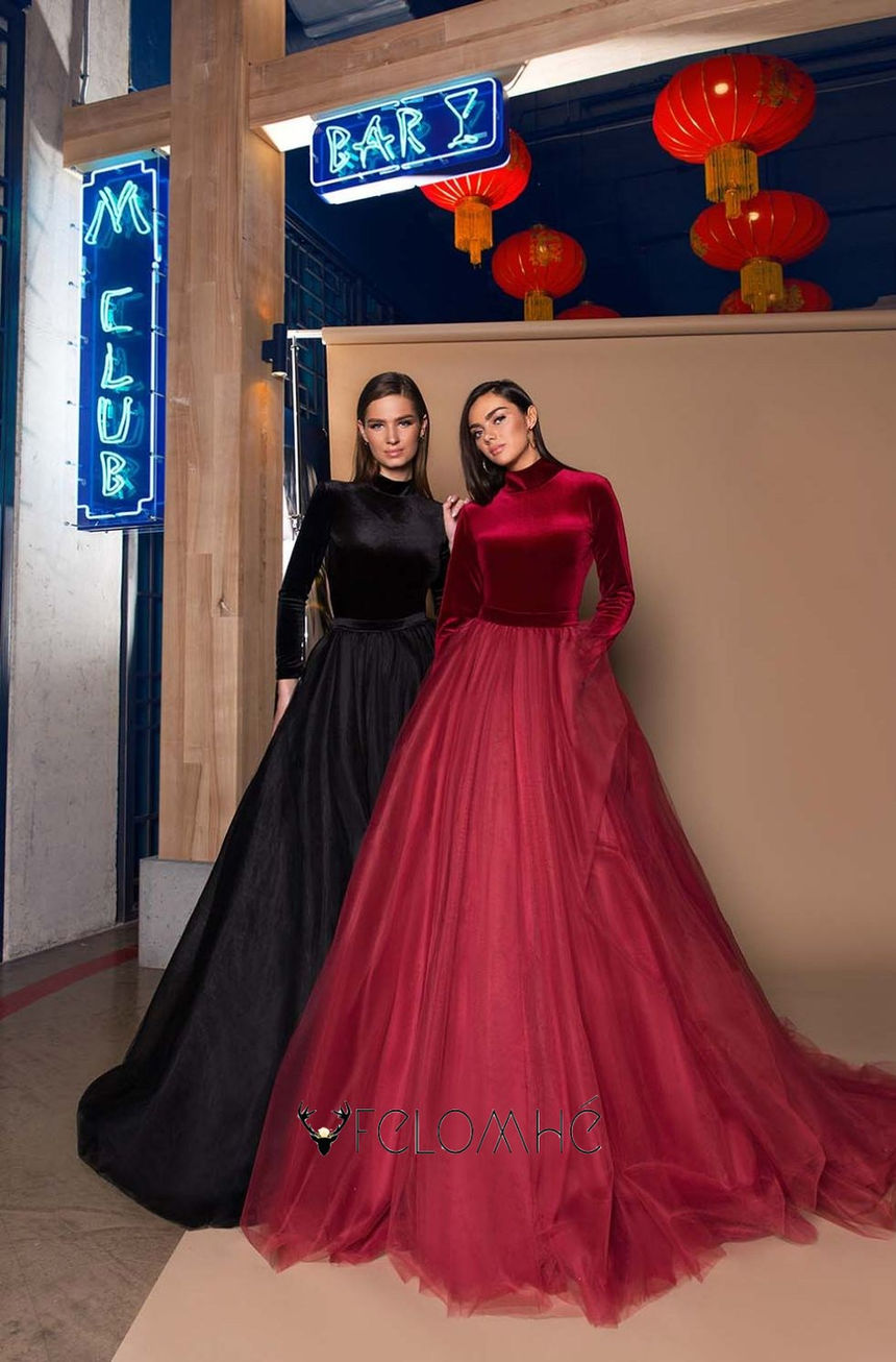 Deep green velvet gown with a high-neck bodice and tulle skirt, creating a royal and sophisticated look.