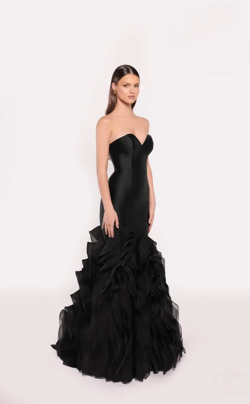 Strapless black mermaid gown with a ruffled cascading skirt.